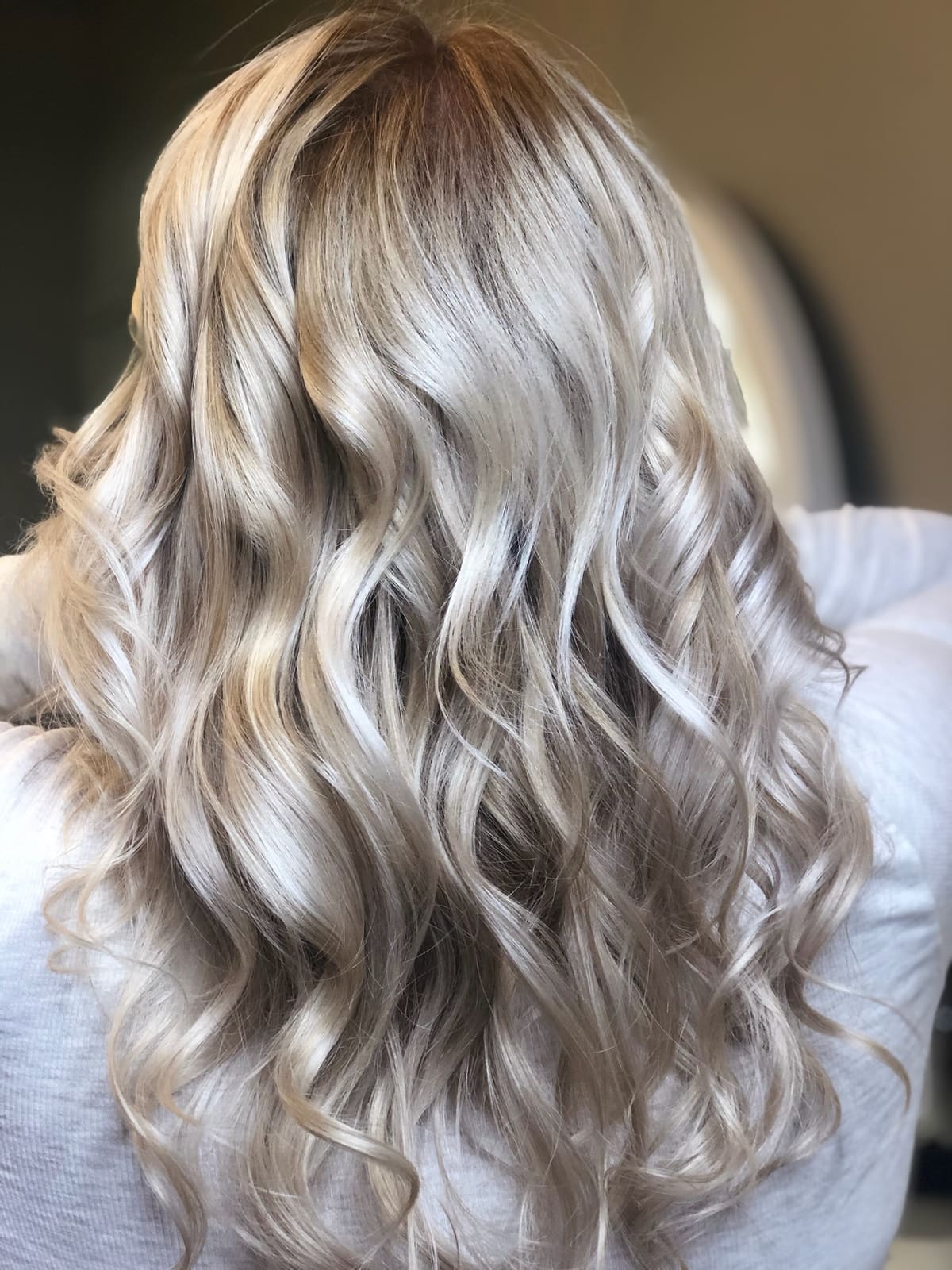 Long icy blonde curls, done at Beauty Collective