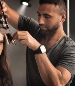 Tarek Makki curling a client's hair